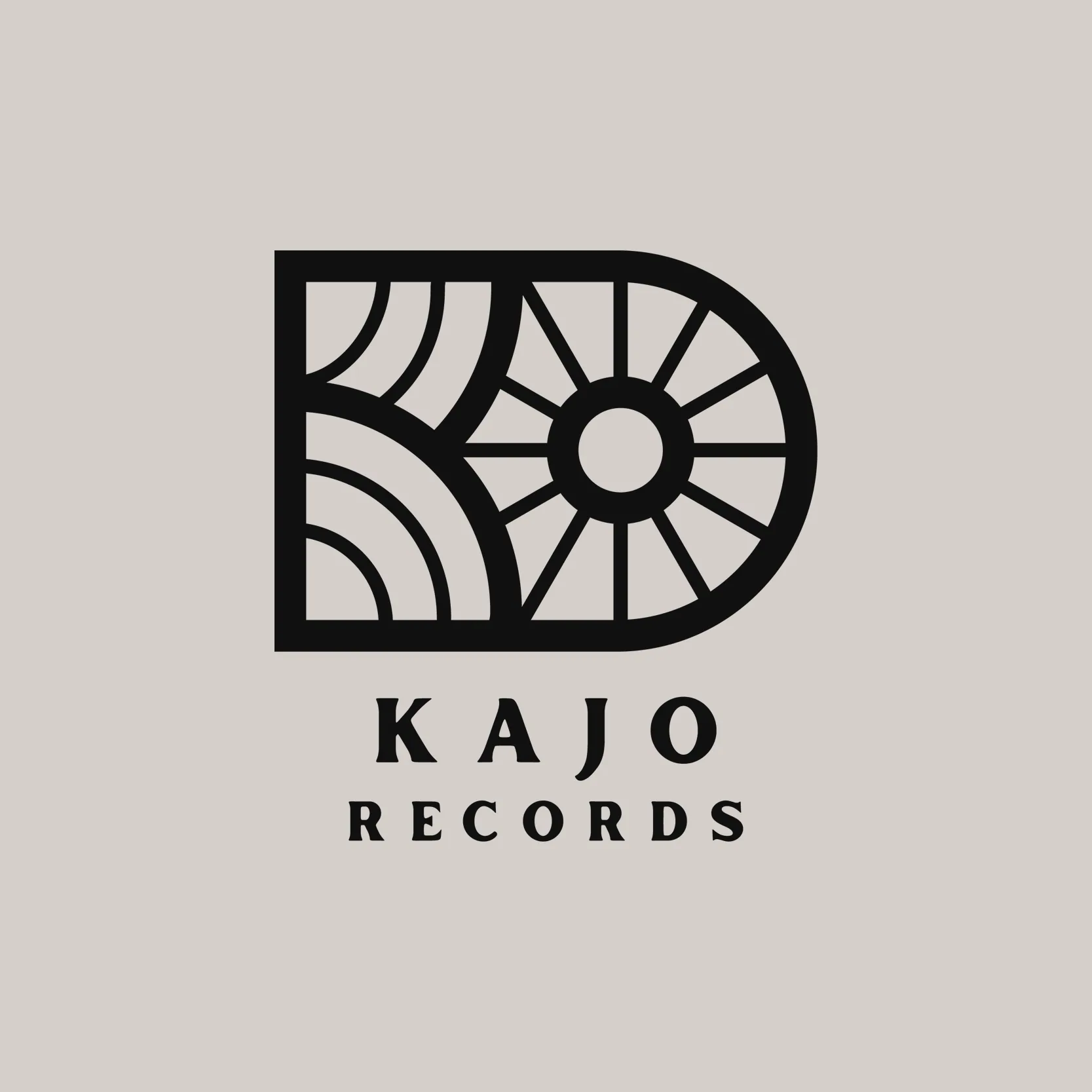 Kajo Records logo: a black D-shaped mark built from a rising sun and rays, above the name in spaced serif capitals.